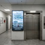 Новостройки Перми и Жилые Комплексы: Выбор и Покупка Недвижимости с Помощью Профессионалов Elevator_corridor_with_advertisi…_202606200943.jpeg